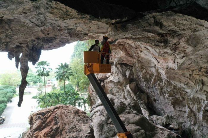 Geofinite engineers inspecting a limestone cliff face from an aerial work platform
