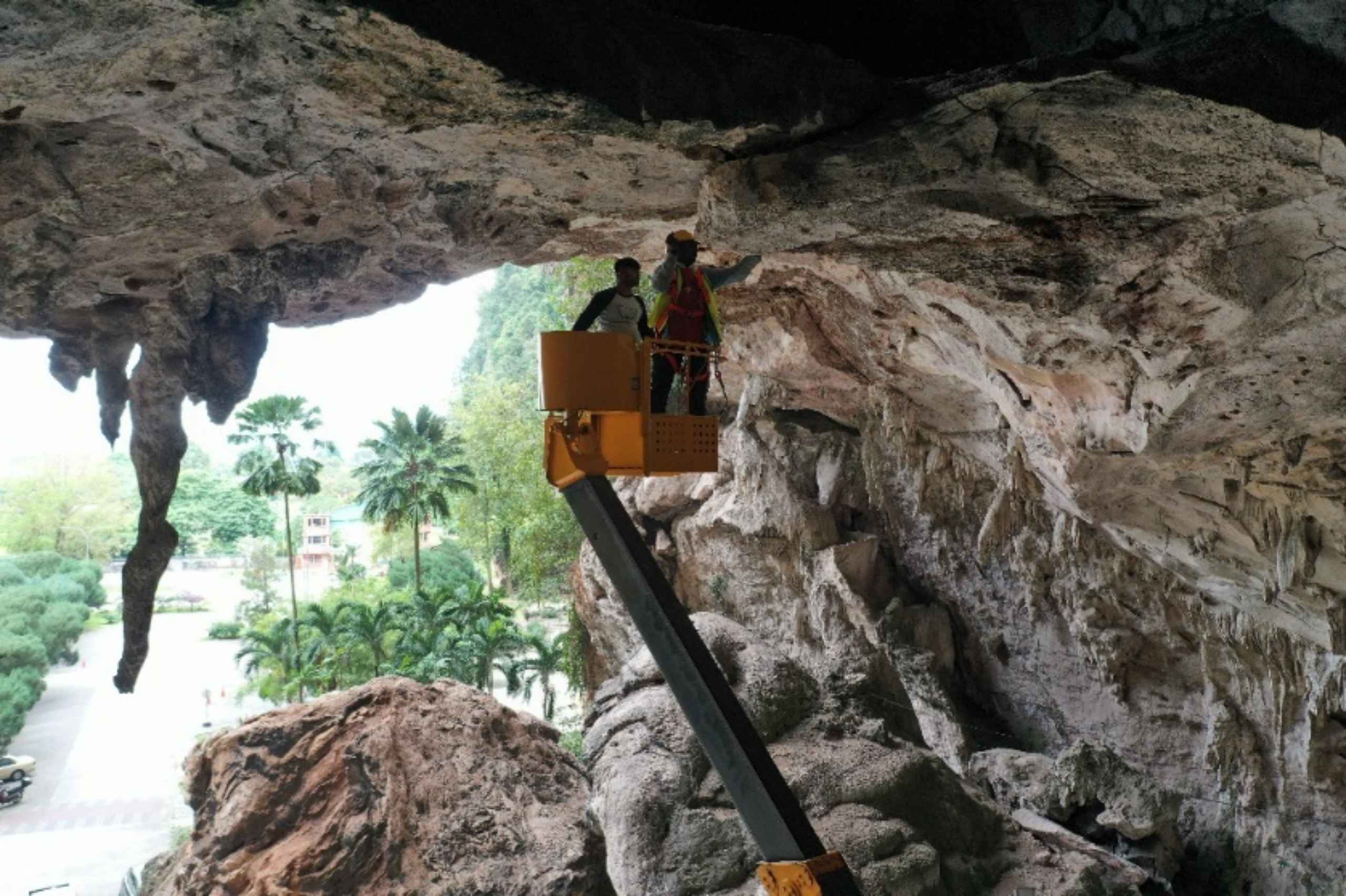 Geofinite engineers inspecting a limestone cliff face from an aerial work platform