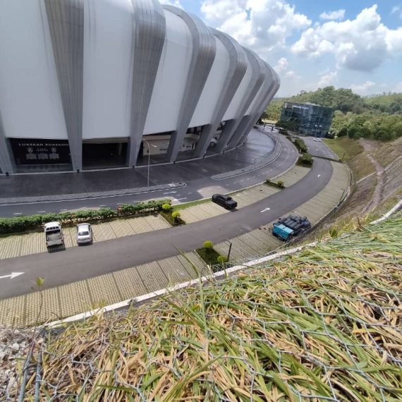 Slope stabilization and erosion control works beside a stadium access road