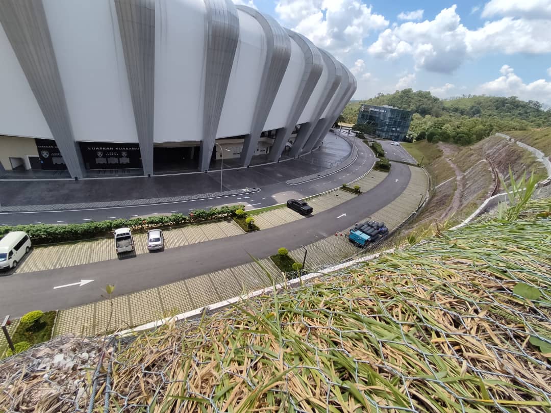 Slope stabilization and erosion control works beside a stadium access road